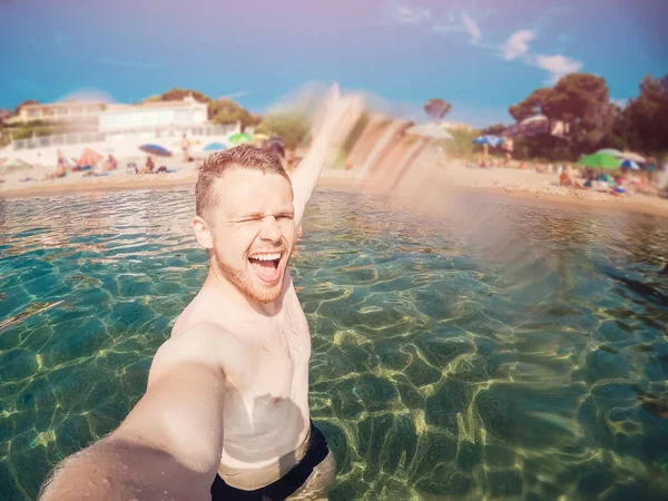 Glad manlig turist på stranden nära havet i Frankrike. Le, ta selfie bilder på actionkamera — Stockfoto