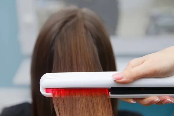 keratin recovery hair and protein treatment pile with professional ultrasonic iron tool.