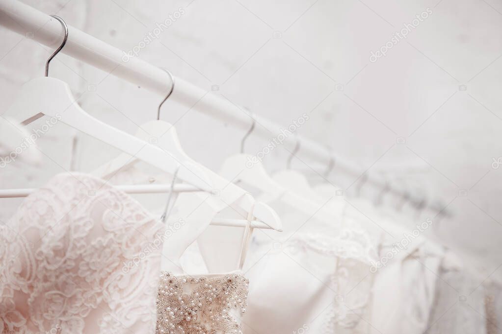 Wedding dresses for bride background of brick in store. Concept wedding, engagement, attributes,