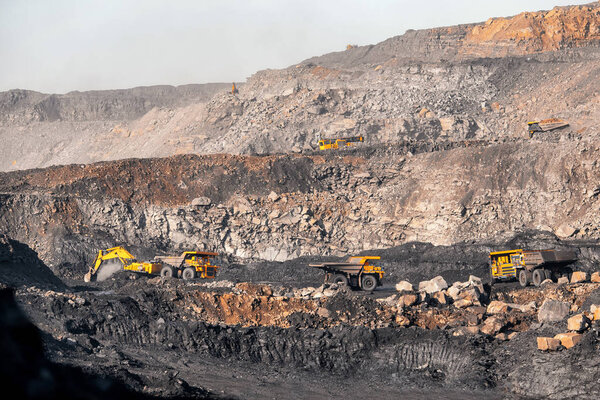 Open pit mine industry. Big yellow mining truck for coal moving on road career
