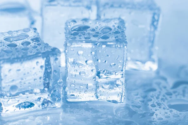 Jégkockák makró négyzet cseppek tiszta víz kék háttér — Stock Fotó