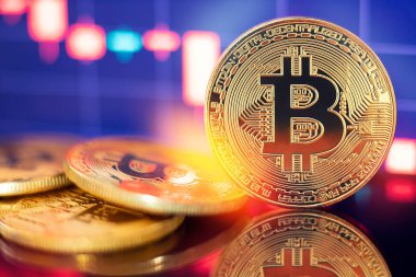Grafik diyagramının arka planında altın Bitcoin kripto para birimi
