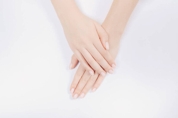 Stylish trendy nail young woman hands pink manicure on white background