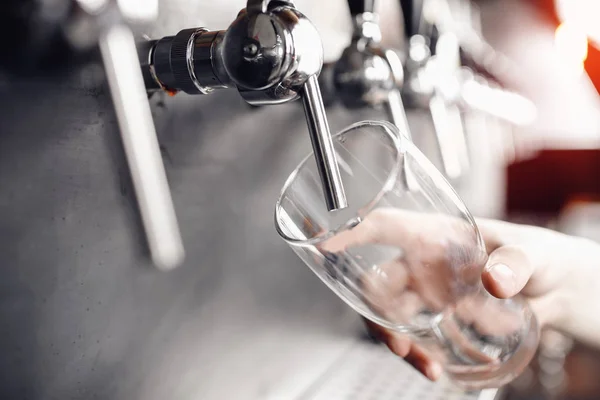 Focus selettivo sul rubinetto per bevande alcoliche artigianali in pub. Il barista versa birra nel bicchiere — Foto Stock