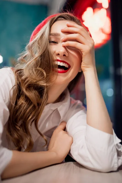 Jovem romântica bonita mulher frança ri sorri em boina vermelha na mesa de café — Fotografia de Stock