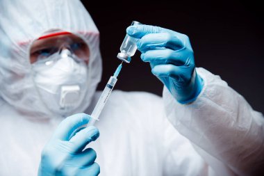 Concept animal medic experiments. Investigation antidote of injection treat dangerous virus. Doctor in hazmat protective with glasses and respirator uses syringe