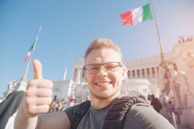 Happy male tourist taking selfie photo on background Venice Square in Rome Italy, blue sky. Travel summer concept