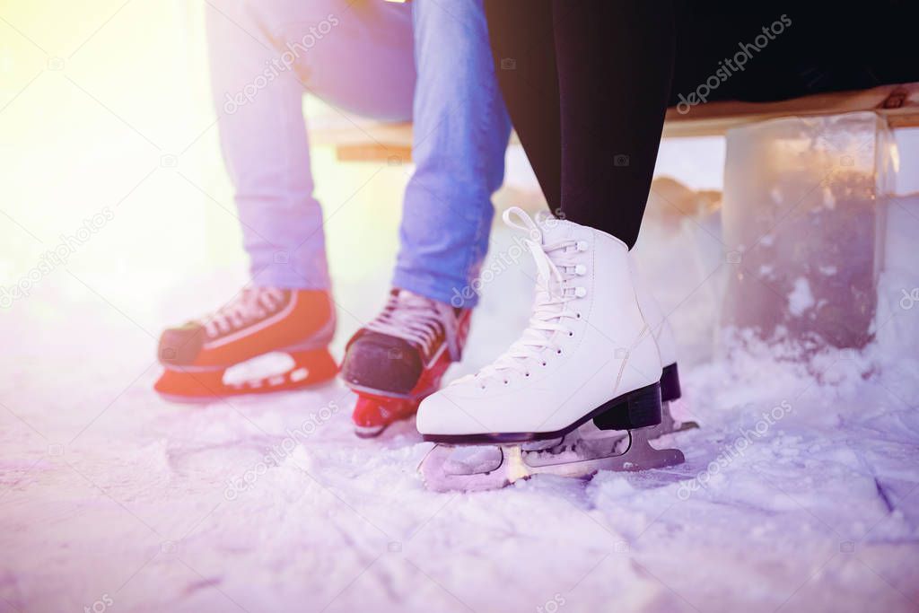 Ice skating lover couple having fun on snow winter holidays night illumination