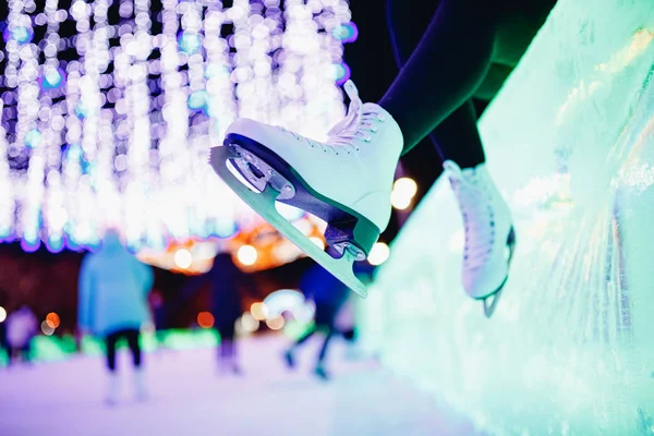 White figure skates on winter ice rink with blurry bokeh background — Stock Photo, Image