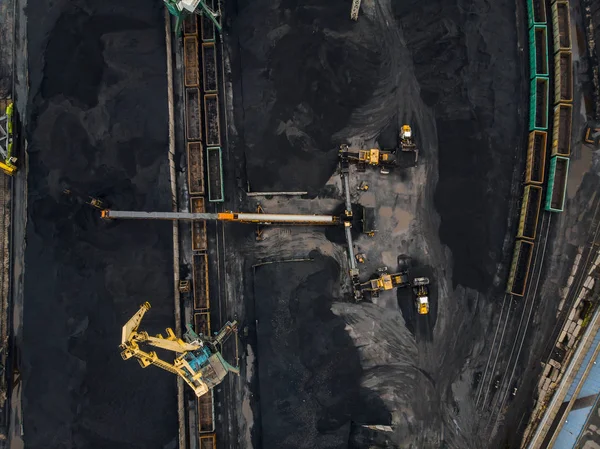 Loading coal anthracite mining in port on cargo tanker ship with crane bucket of train. Aerial top view — Stock Photo, Image