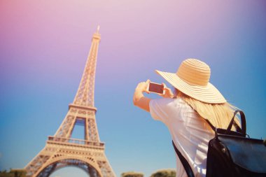 Girl tourist Eiffel tower making selfie. Beautiful European enjoying vacation in Paris, France. Concept travel