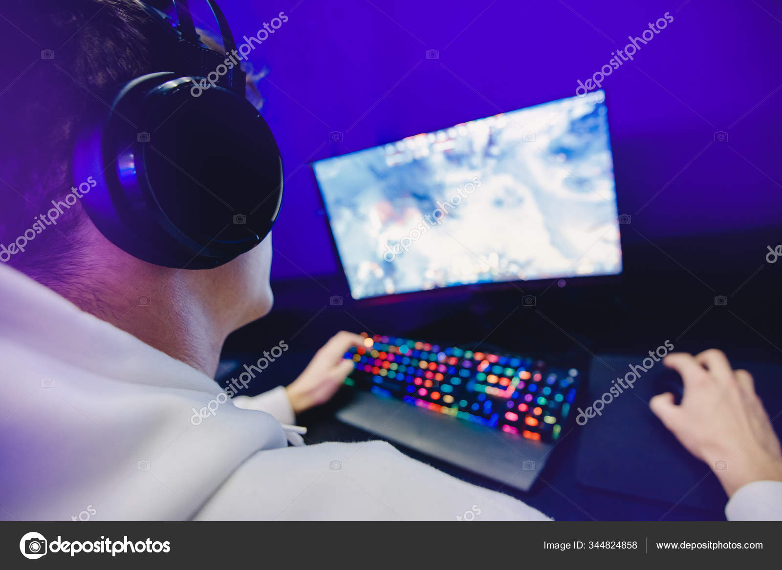 Professional gamer playing tournaments online video games computer with headphones, red and blue Stock Photo by ©ParStud 344824858