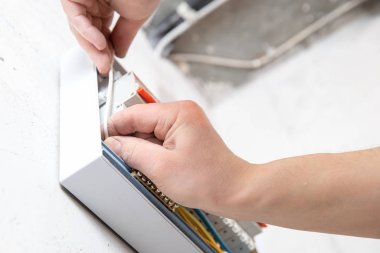 Electrician mounts consumer electric switchboard control panel for home enclosure for distribution and power electricity