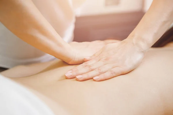 Young woman relaxing with hand professional back massage beauty spa — Stock Photo, Image