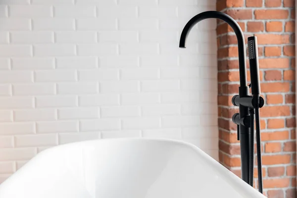 Black shower system for white loft style bathroom