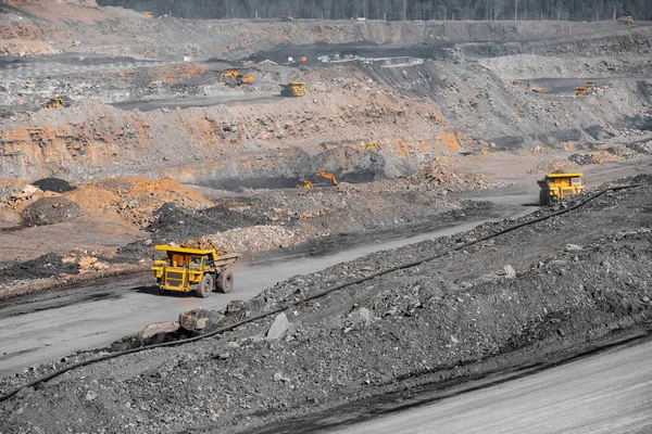 Industria mineraria a cielo aperto. Camion da miniera giallo per il trasporto del carbone ai carichi dell'escavatore — Foto Stock