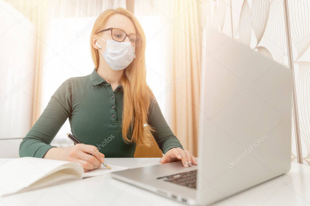 Girl student is studying remotely from home computer online classes university quarantine