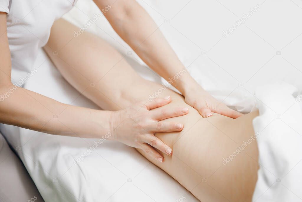 Anti varicose veins legs massage of young women beauty spa