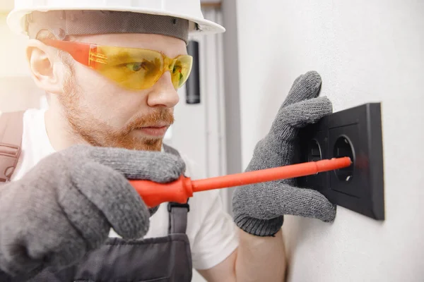 Electrician builder install working switches and sockets black color loft style — Stock Photo, Image