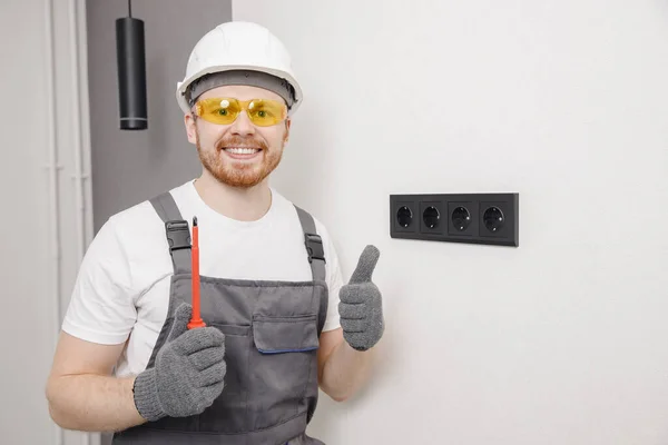 Electrician builder install switches and sockets screwdriver tool working — Stock Photo, Image