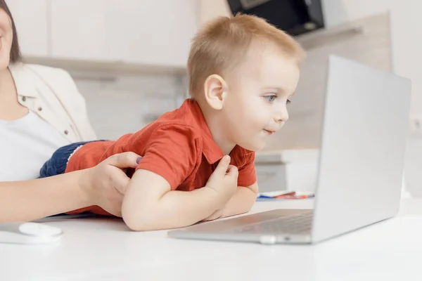 Boy child enthusiastically watching video blog or cartoons on laptop screen. Concept myopia, internet addiction — Stock Photo, Image