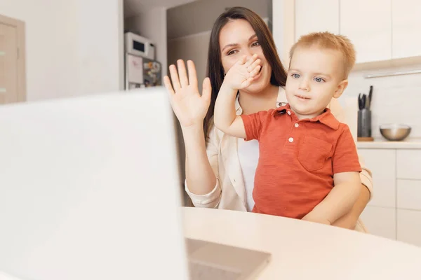 Mom and son are talking web video online chat with family. Communication quarantine people concept