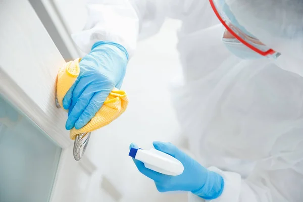 생화학 슈트의 바이러스와 미생물에 감염되어 집을 소독하고 청소하는 문 손잡이. 코로나 바이러스 보호 개념 — 스톡 사진