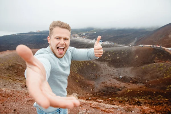 Tourist climbed top of volcano Mount Etna, Sicily Italy. Concept of trekking travel mountains