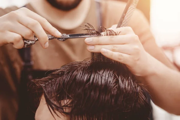 Barbershop banner. Man in barber chair, hairdresser styling his hair.