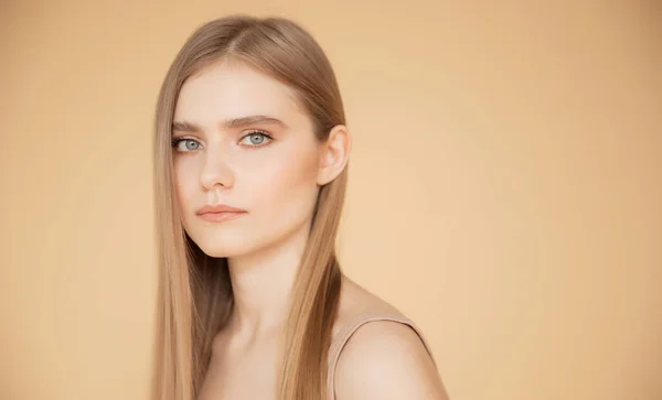 Piękny portret młodej kobiety na beżowym tle, skóra i pielęgnacja włosów Beauty face concept — Zdjęcie stockowe