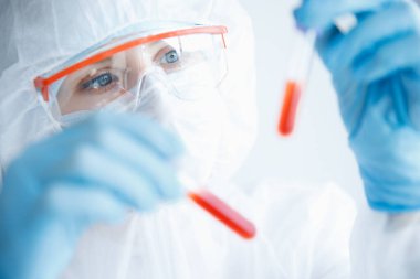 Çin 'deki ve Dünya' daki Coronavirus virüsünün analizi. Laboratuvarda solunum cihazıyla koruyucu kimya giysisi giyen doktor.
