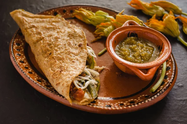 mexican quesadilla with squash blossom, cheese and spicy sauce in mexico