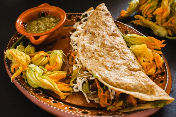 mexican quesadilla with squash blossom, cheese and spicy sauce in mexico