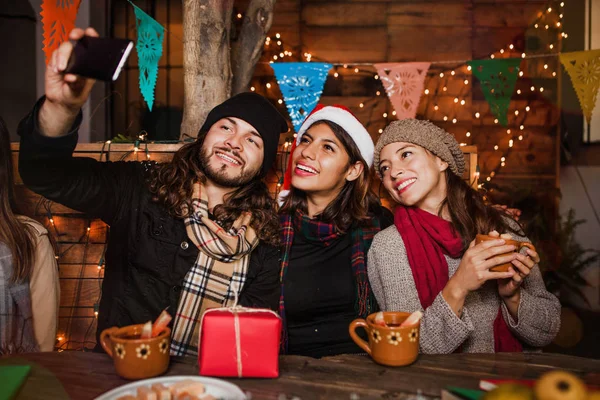 Mexican Posada friends celebrating Christmas in Mexico and taking a photo selfie — Stock Photo, Image