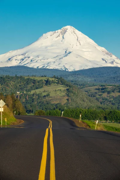 Eastern side of Mount Hood rising above a highway in Oregon