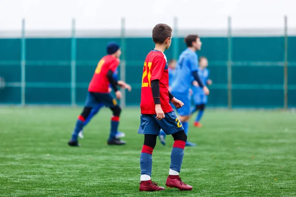 Boys Red Blue Sportswear Plays Football Field Dribbles Ball Young — Stock Photo, Image