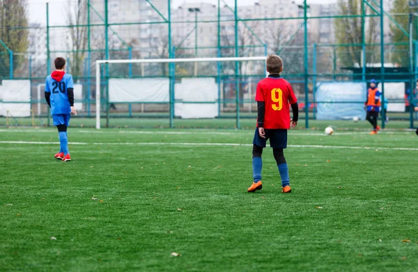 Boys Red Blue Sportswear Plays Football Field Dribbles Ball Young — Stock Photo, Image