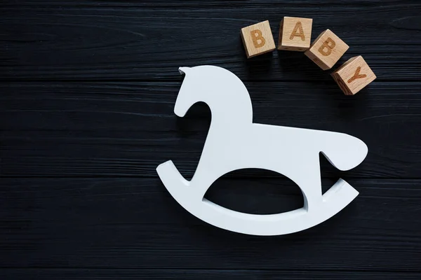 Wooden toy horse and cubes with the inscription of \