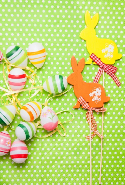 Easter bunny and eggs on green background — Stock Photo, Image