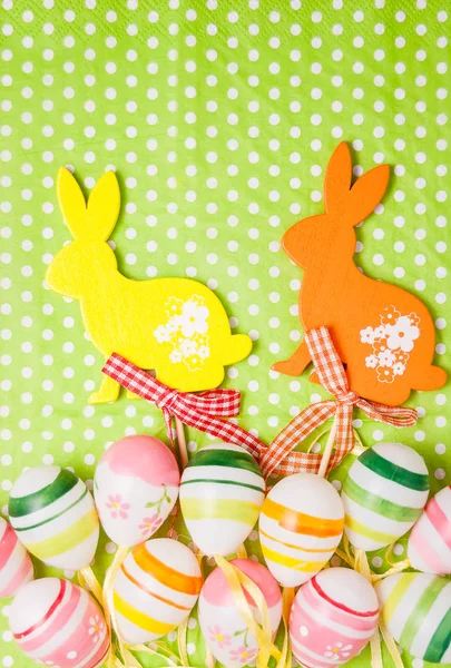 Easter bunny and eggs on green background — Stock Photo, Image