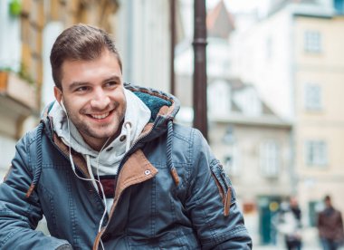 Yakın çekim gülümseyen genç bir adam. Neşeli adam gülüyor