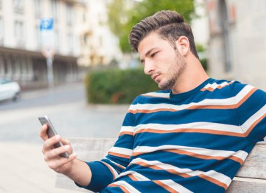 Closeup young man using smartphone shopping online