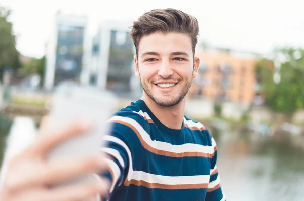 Smiling guy take selfie photo