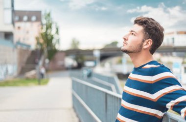 Profil - genç ve güzel bir adamın yan görünüşü. Yakışıklı bir adam, açık havada.