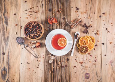 Bir fincan portakallı meyve çayı ve ahşap masada tarçın. Üst görünüm, yukarıdan