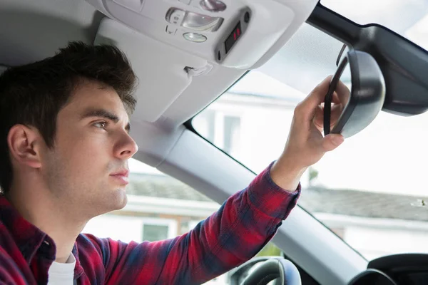 Young Male Driver In Car Checking Rear View Mirror — Stock Photo, Image
