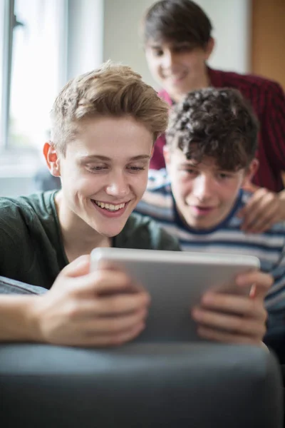 Three Teenage Boys Playing Game On Digital Tablet At Home — Stock Photo, Image