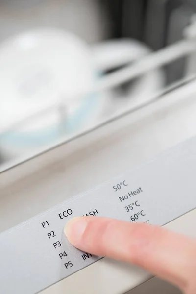 Woman Selecting Economy Program On Dishwasher To Save Energy — Stock Photo, Image