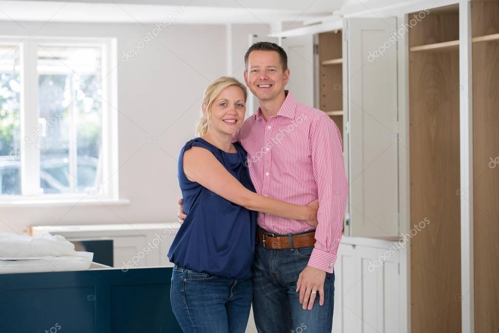Portrait Of Mature Couple At Home As New Luxury Kitchen Is Fitte