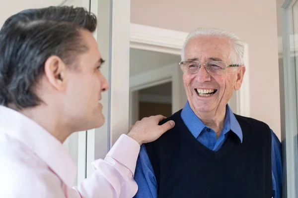 Man Checking On Elderly Female Neighbor — Stock Photo, Image